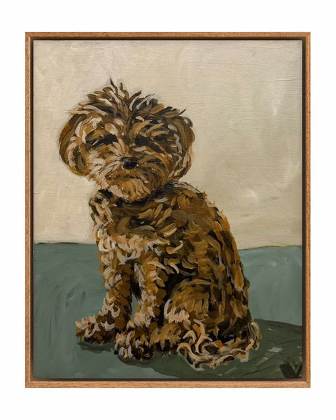 Framed artwork of a small brown dog sitting on a green mat with a beige background,  a pet portrait