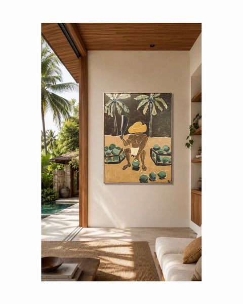 A framed art painting featuring a person figure in a straw hat among palm trees, displayed on a beige wall in a modern, sunlit interior with wooden ceiling panels and a sofa, in a tropical scene
